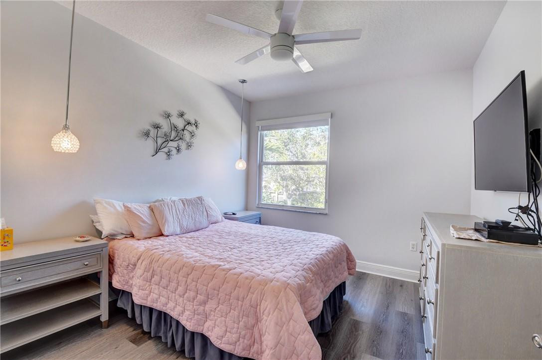 11750 Bayfield Drive Boca Raton, FL 33498 - Photo 62 of 70 a bedroom with a bed and a flat screen tv