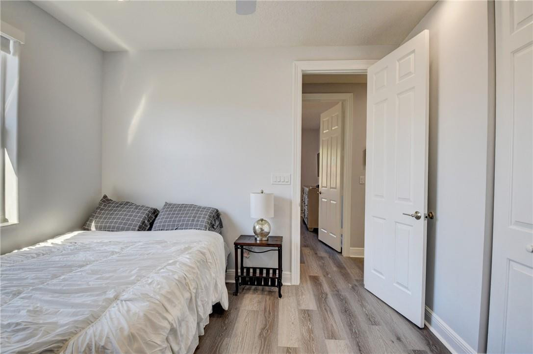 11750 Bayfield Drive Boca Raton, FL 33498 - Photo 65 of 70 a bedroom with a bed and wooden floor