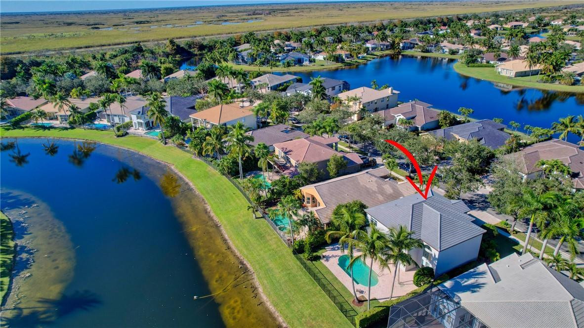 11750 Bayfield Drive Boca Raton, FL 33498 - Photo 9 of 70 an aerial view of a house with a garden and lake view