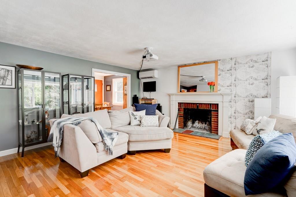 123 Harvard Road Littleton, MA 01460 - Photo 3 of 25 a living room with furniture and a fireplace