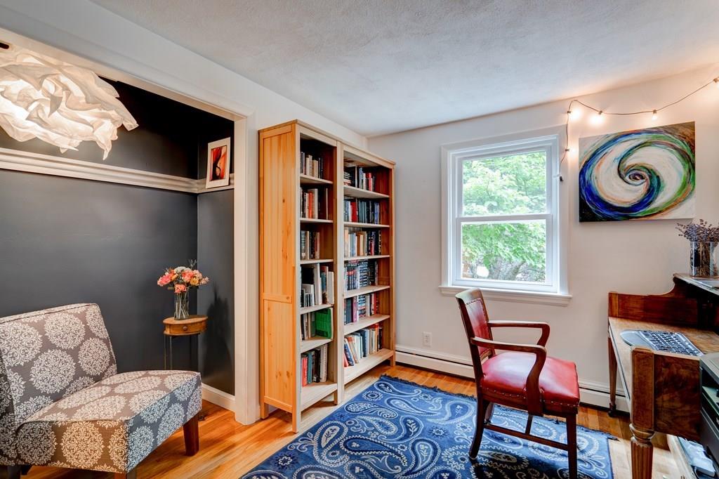 123 Harvard Road Littleton, MA 01460 - Photo 9 of 25 a living room with furniture and a book shelf