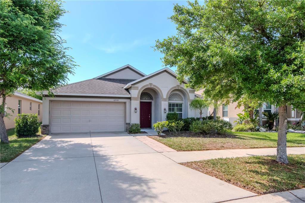a front view of a house with a yard and garage