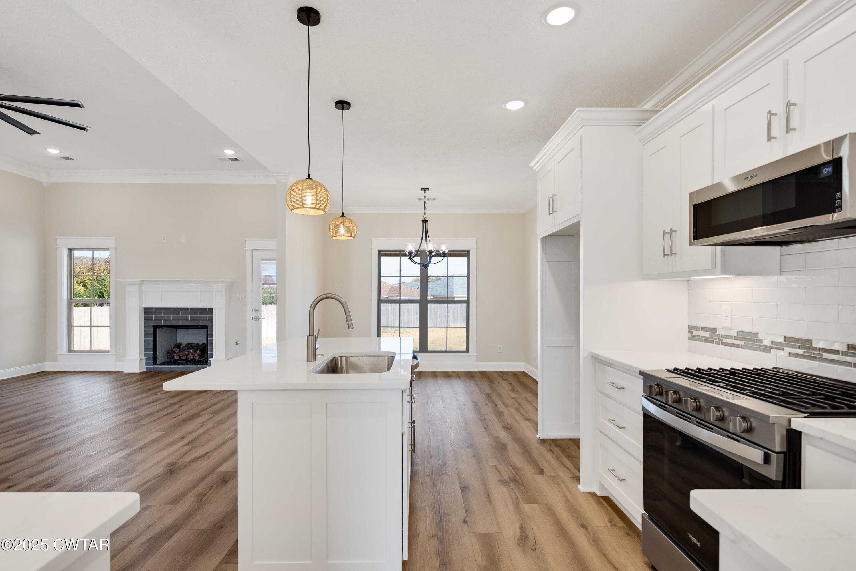 16 Enoch Cove Jackson, TN 38305 - Photo 11 of 28 a kitchen with stainless steel appliances granite countertop a stove a sink and a wooden floor