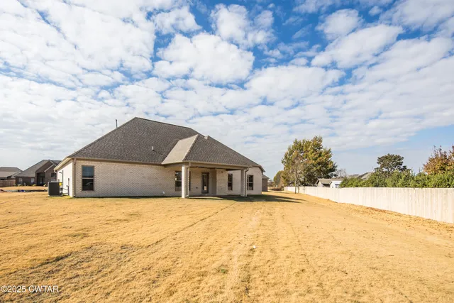 a white house with a large tree in front of it