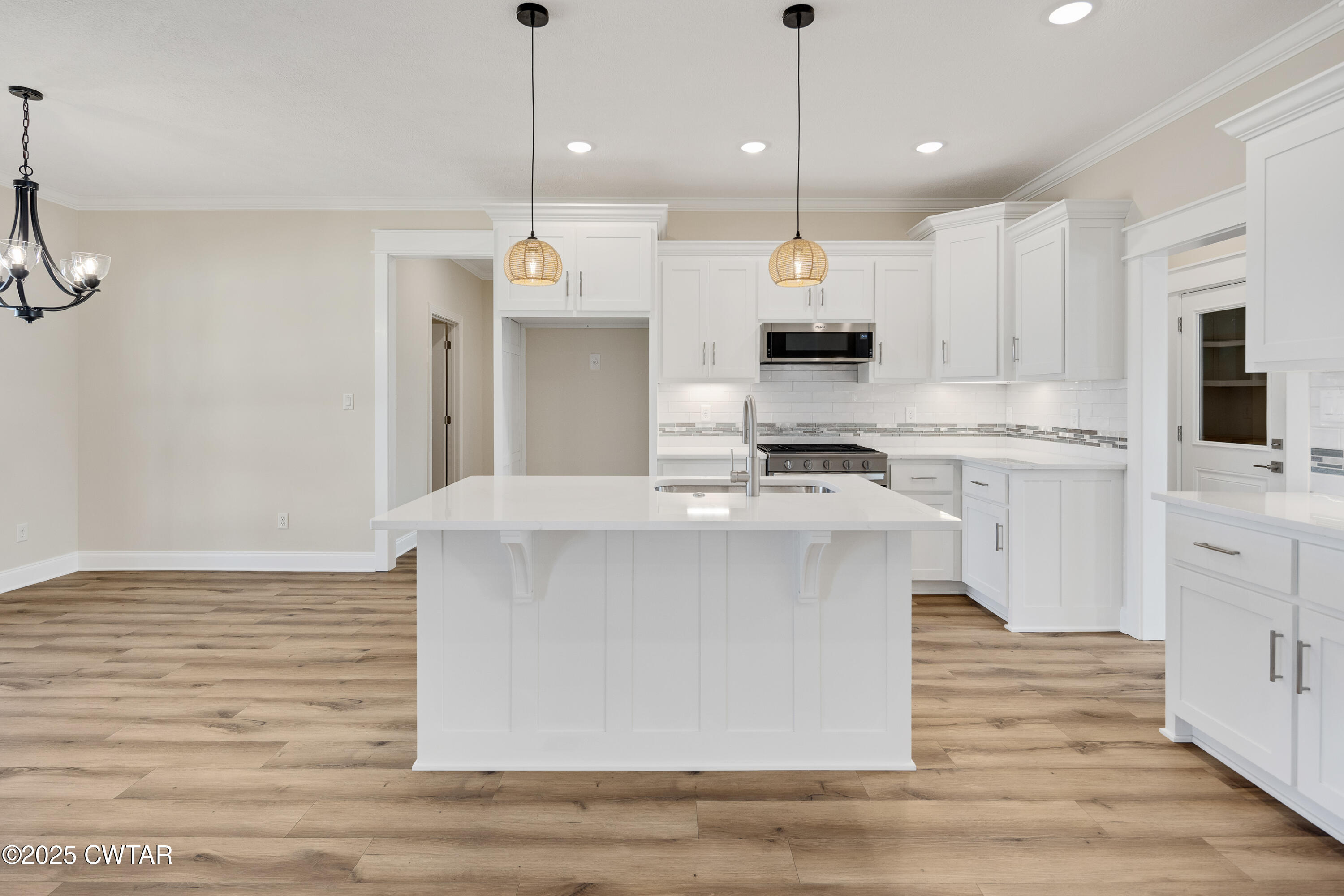 16 Enoch Cove Jackson, TN 38305 - Photo 10 of 28 a kitchen with kitchen island a stove a sink and a refrigerator
