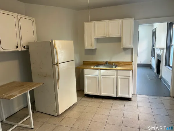a kitchen with a stove a refrigerator and a cabinets