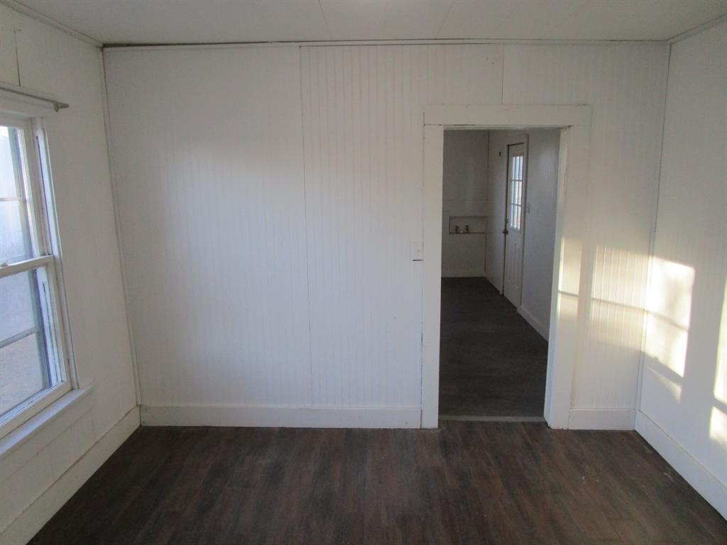 220 Southwest 5th Street Hamlin, TX 79520 - Photo 19 of 28 wooden floor in an empty room