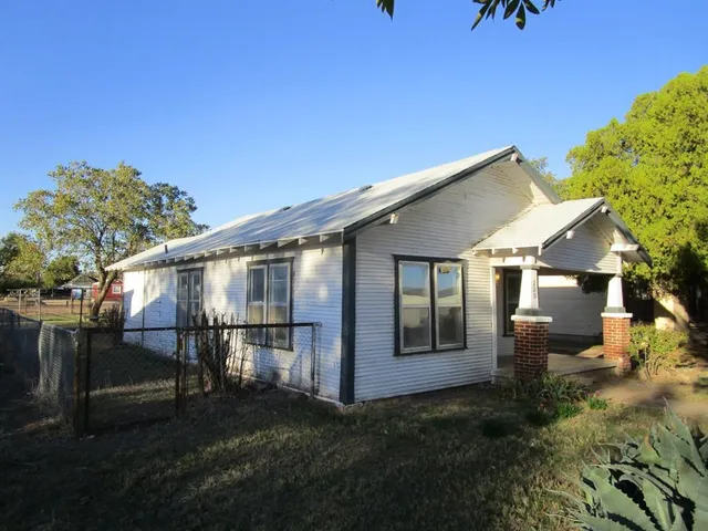 a view of a house with backyard porch and sitting area