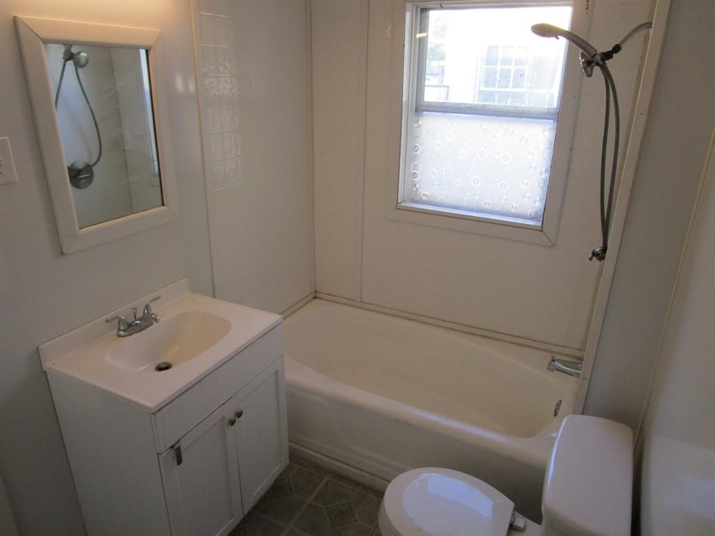 220 Southwest 5th Street Hamlin, TX 79520 - Photo 23 of 28 a bathroom with a sink toilet and shower