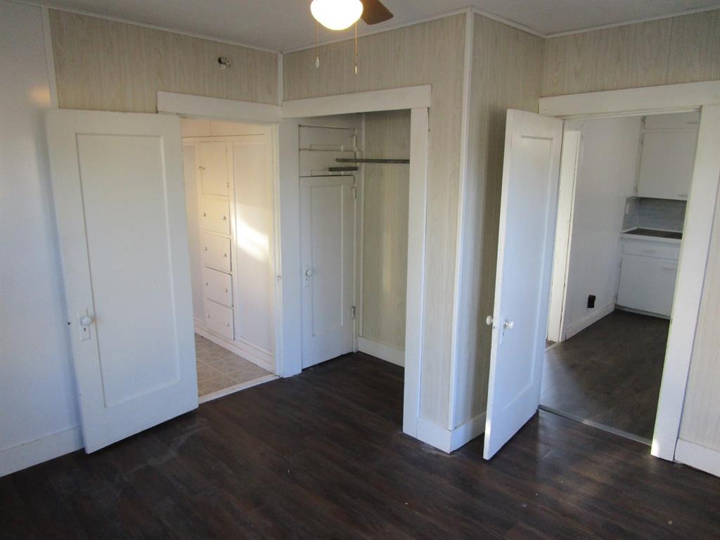 220 Southwest 5th Street Hamlin, TX 79520 - Photo 25 of 28 an empty room with wooden floor & closet area