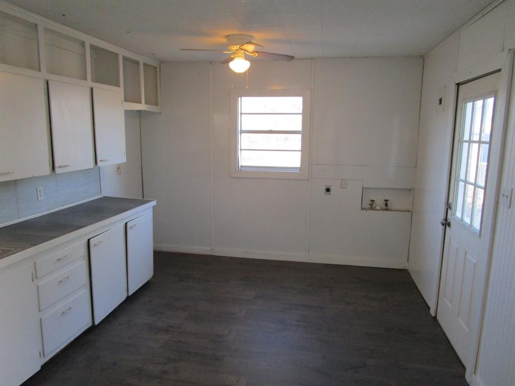 220 Southwest 5th Street Hamlin, TX 79520 - Photo 27 of 28 a kitchen with cabinets appliances and a window