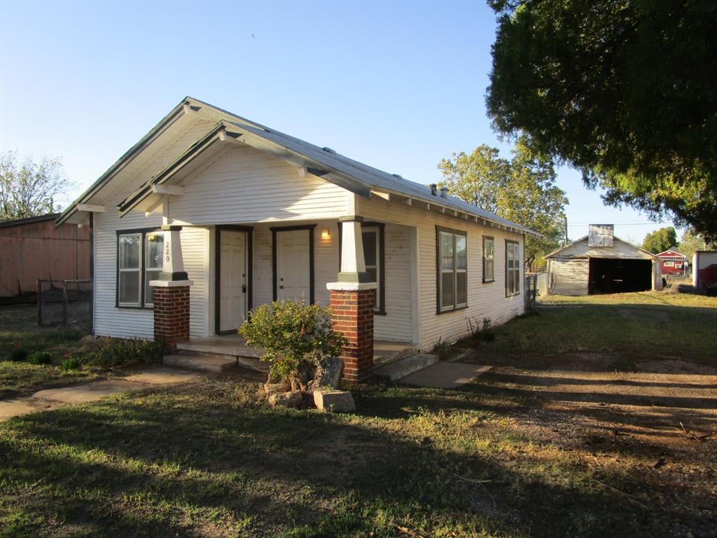 220 Southwest 5th Street Hamlin, TX 79520 - Photo 3 of 28 a front view of a house with a yard