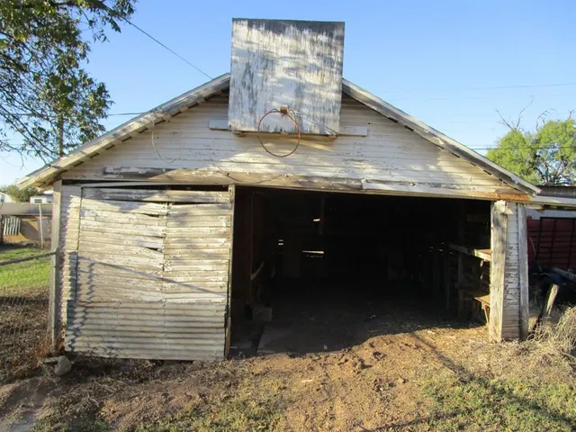 a view of an empty room with a brick wall
