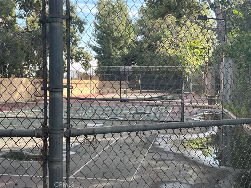 2733 Quail Ridge Circle, Unit 32 Fullerton, CA 92835 - Photo 25 of 25 a view of a wooden fence and a tree