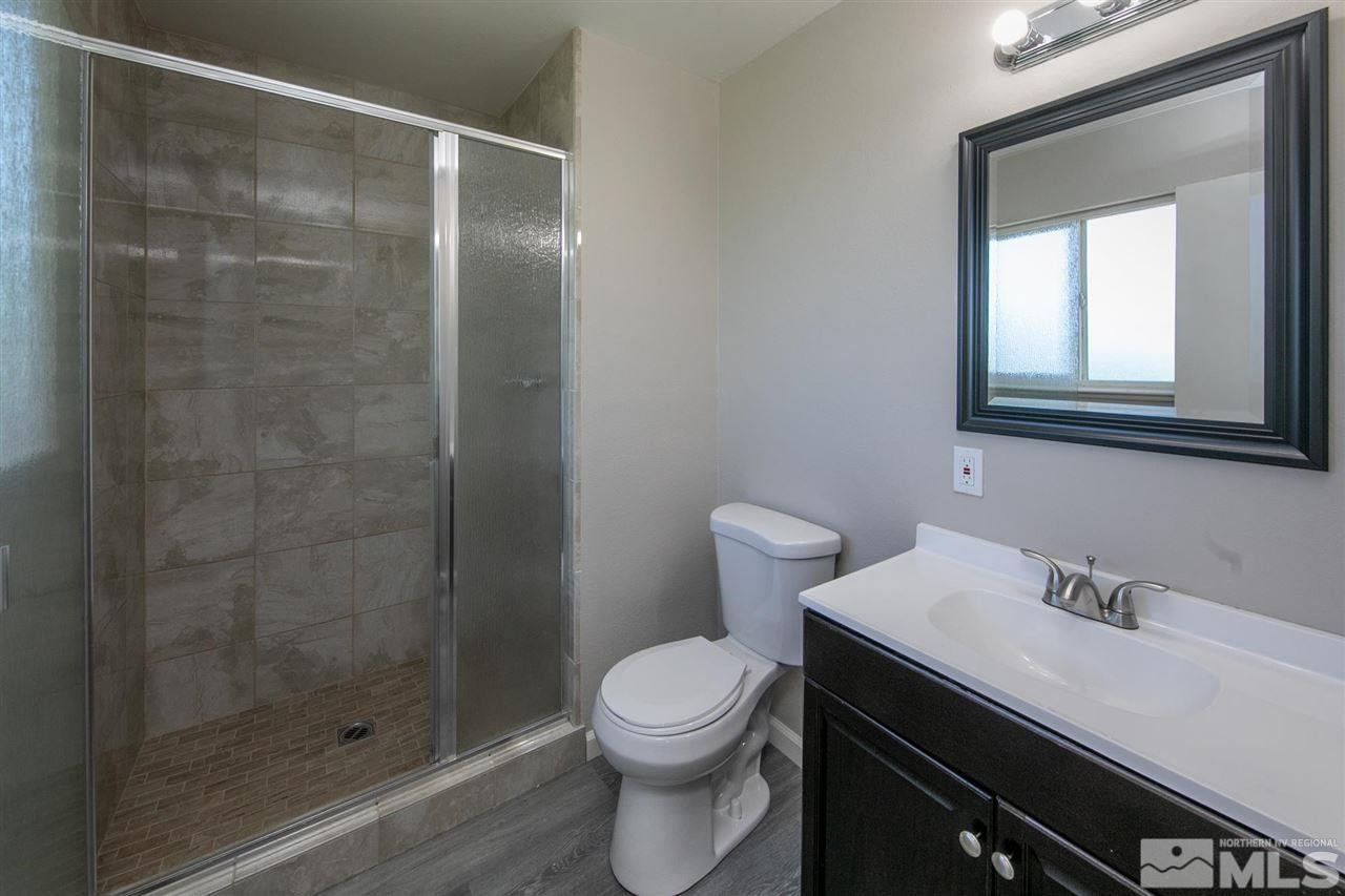 1520 Surf Way Reno, NV 89503 - Photo 16 of 32 a bathroom with a sink a toilet and shower