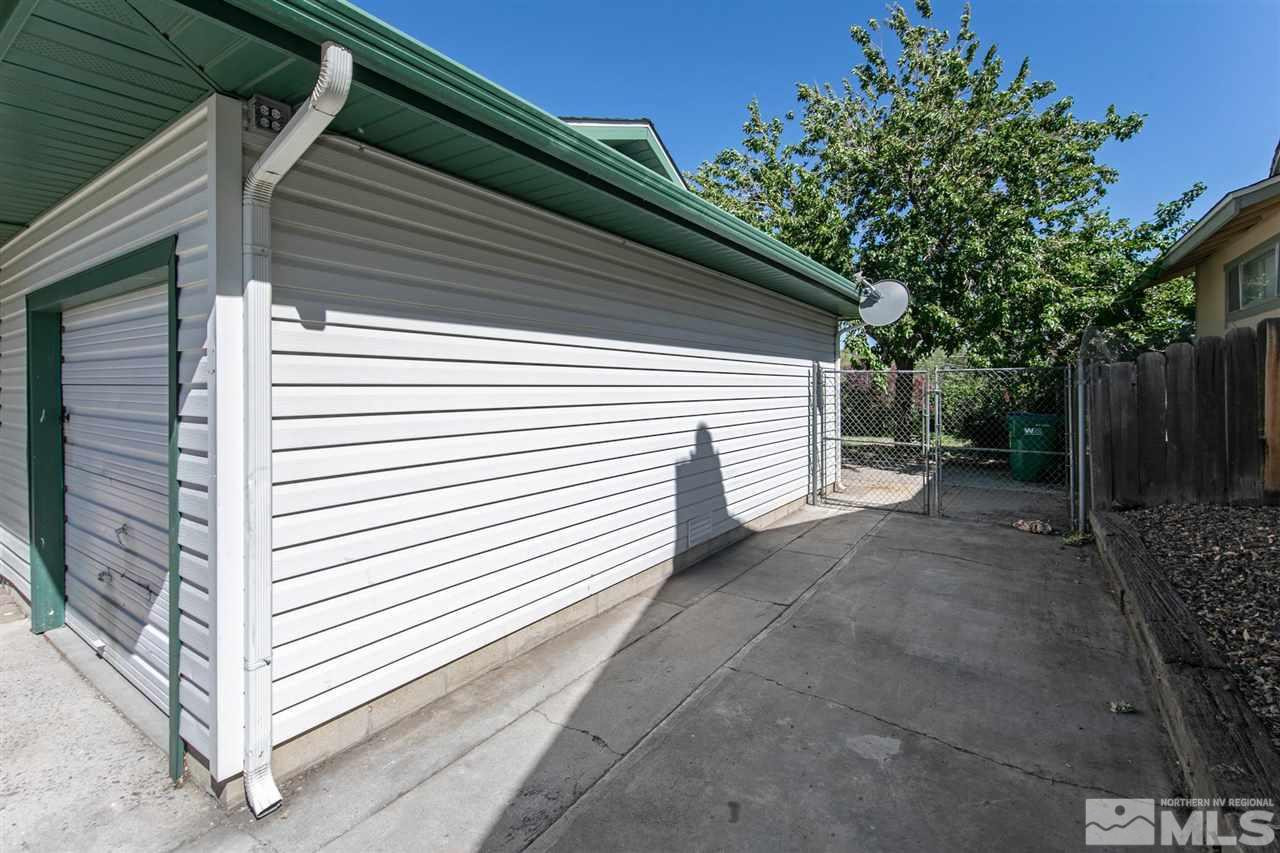 1520 Surf Way Reno, NV 89503 - Photo 5 of 32 a view of backyard with small cabin and wooden fencing