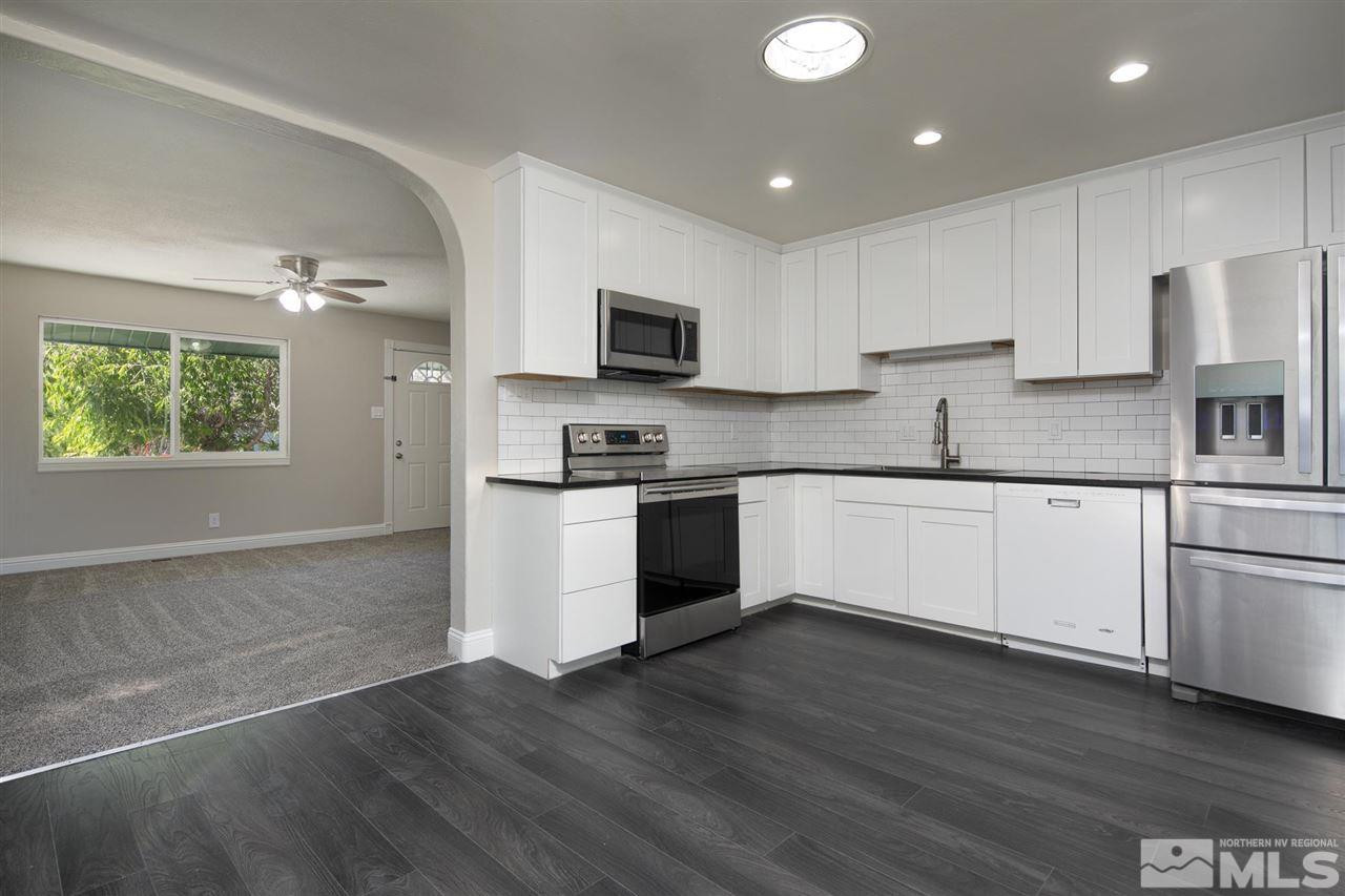 1520 Surf Way Reno, NV 89503 - Photo 10 of 32 a kitchen with a white cabinets and wooden floor