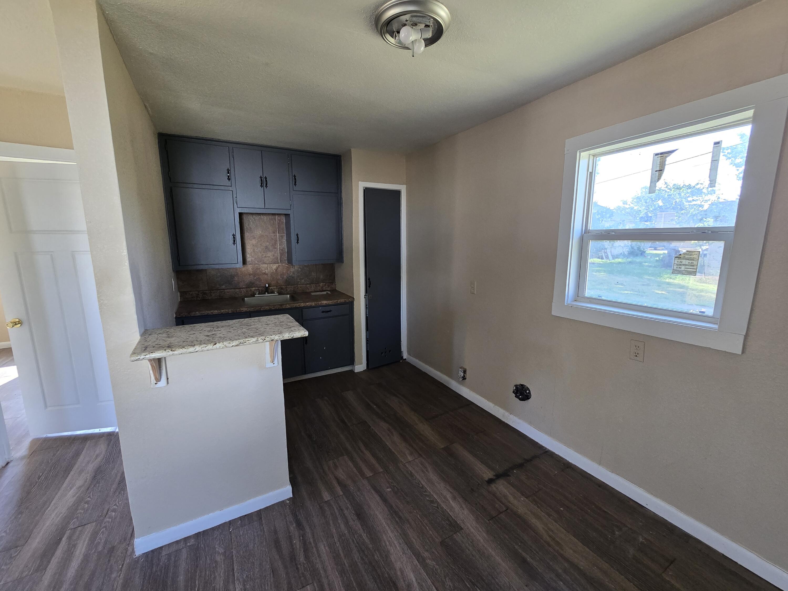 711 Fresno Plainview, TX 79072 - Photo 11 of 13 a kitchen with a refrigerator and a stove top oven