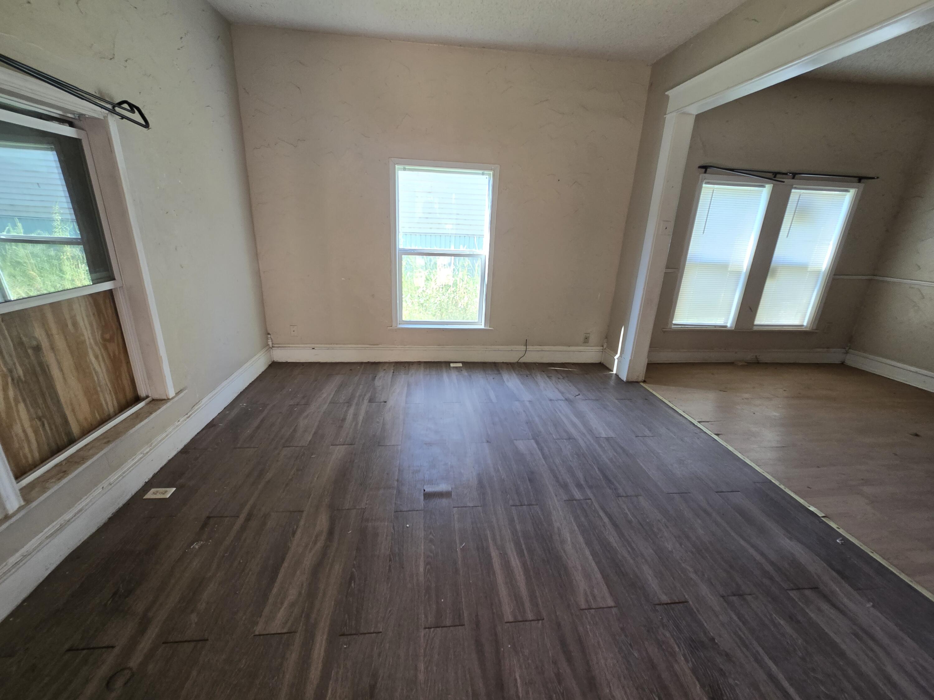 711 Fresno Plainview, TX 79072 - Photo 2 of 13 a view of a room with wooden floor and window
