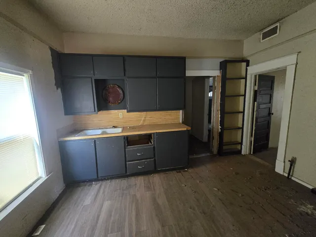 a room with cabinets and wooden floor