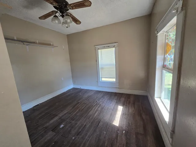 wooden floor in an empty room with a window
