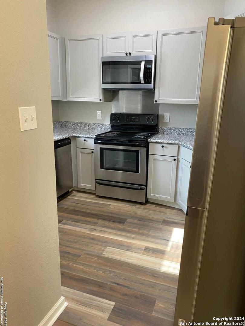 a kitchen with stainless steel appliances a refrigerator stove and sink