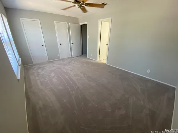 a view of a room with a ceiling fan