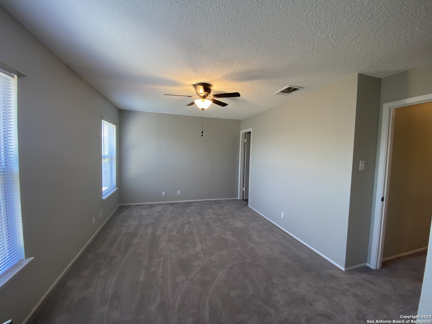 8404 Forest Ridge Drive San Antonio, TX 78239 - Photo 5 of 18 an empty room with ceiling fan and window