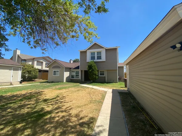a view of a kitchen with a sink and a refrigerator