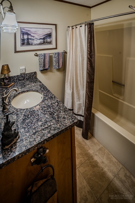 103-105 Upper Grouse Ridge Road Beech Mountain, NC 28604 - Photo 23 of 48 a bathroom with a granite countertop sink and a mirror