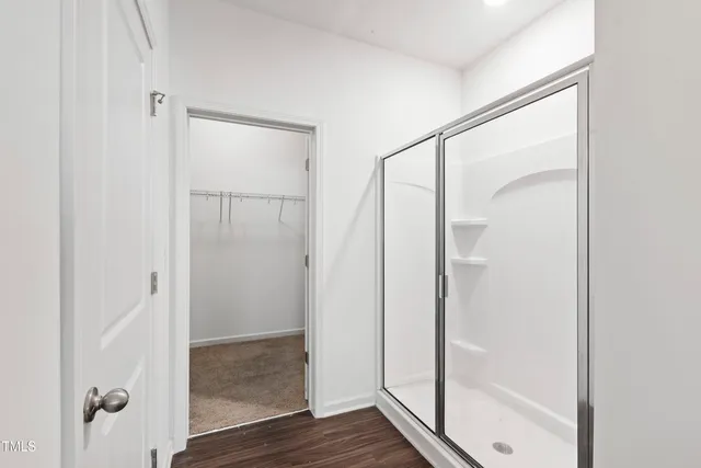 a bathroom with a glass shower door