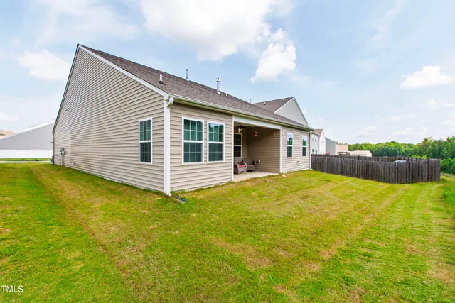 a view of a house with pool and a yard