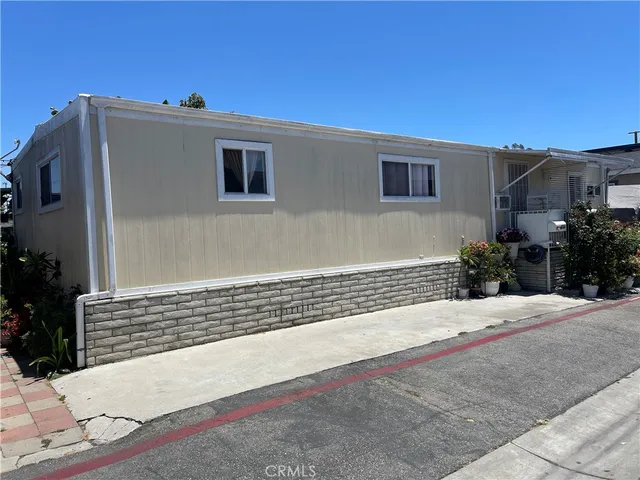 a side view of a house with a yard