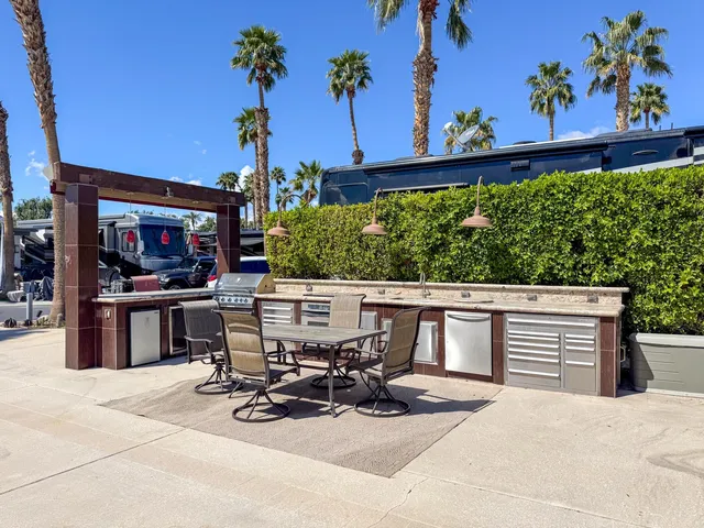 a view of a patio with table and chairs and potted plants