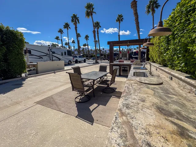 a view of a patio with a table and chairs