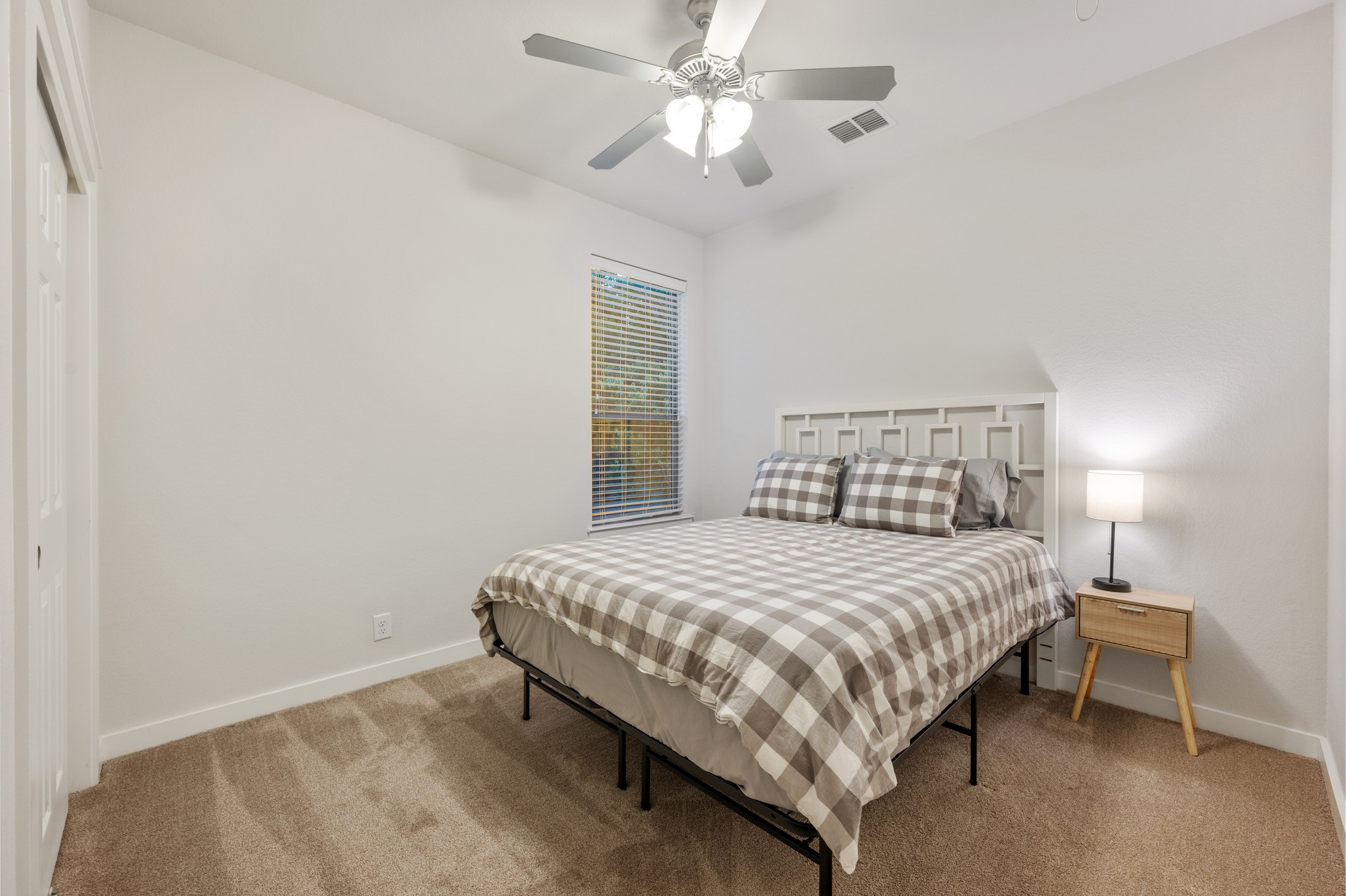 2101 Rivers Edge Way, Unit 19 Austin, TX 78741 - Photo 16 of 24 a bedroom with a bed and a ceiling fan