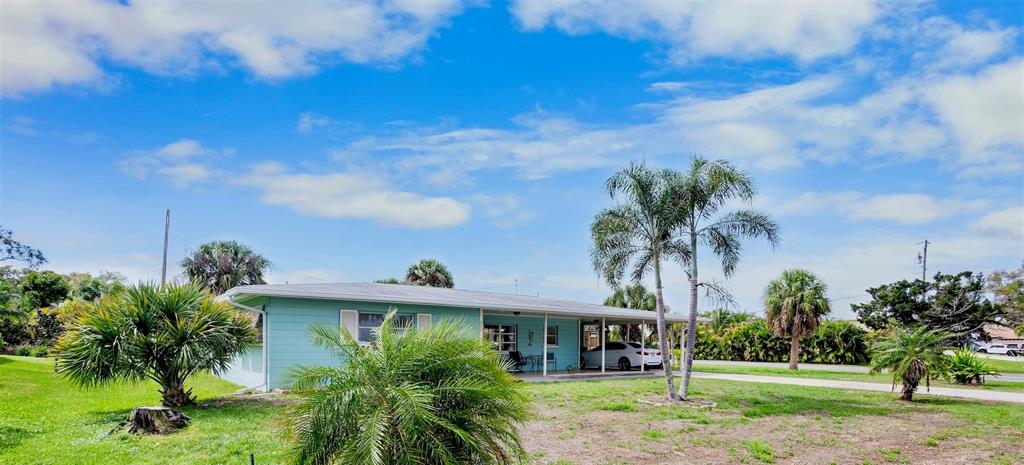 223 Roberts Road Nokomis, FL 34275 - Photo 1 of 27 a front view of a house with a yard
