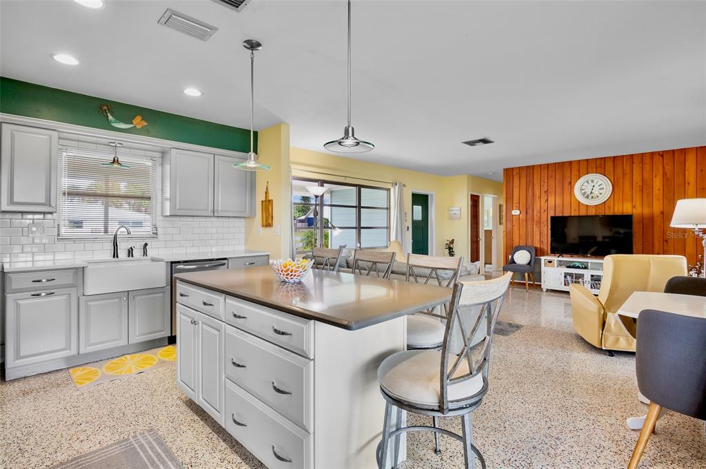 223 Roberts Road Nokomis, FL 34275 - Photo 11 of 27 a kitchen with stainless steel appliances granite countertop a sink a stove and a wooden floors