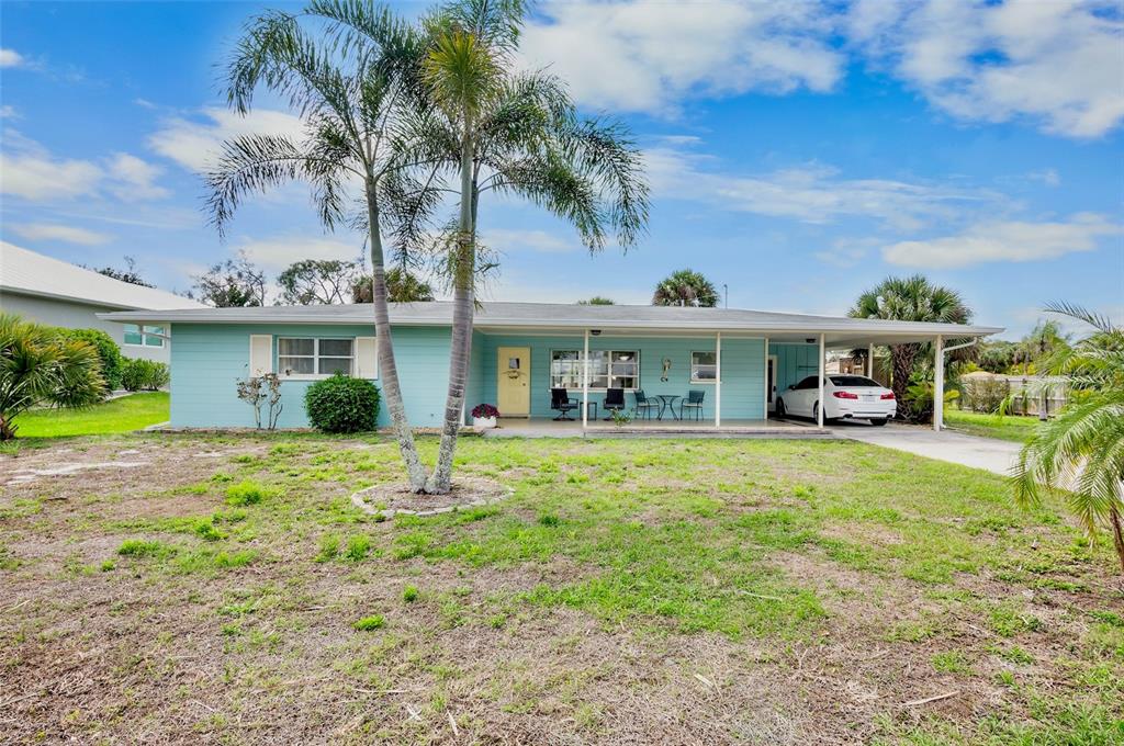 223 Roberts Road Nokomis, FL 34275 - Photo 3 of 27 a front view of a house with a garden and yard