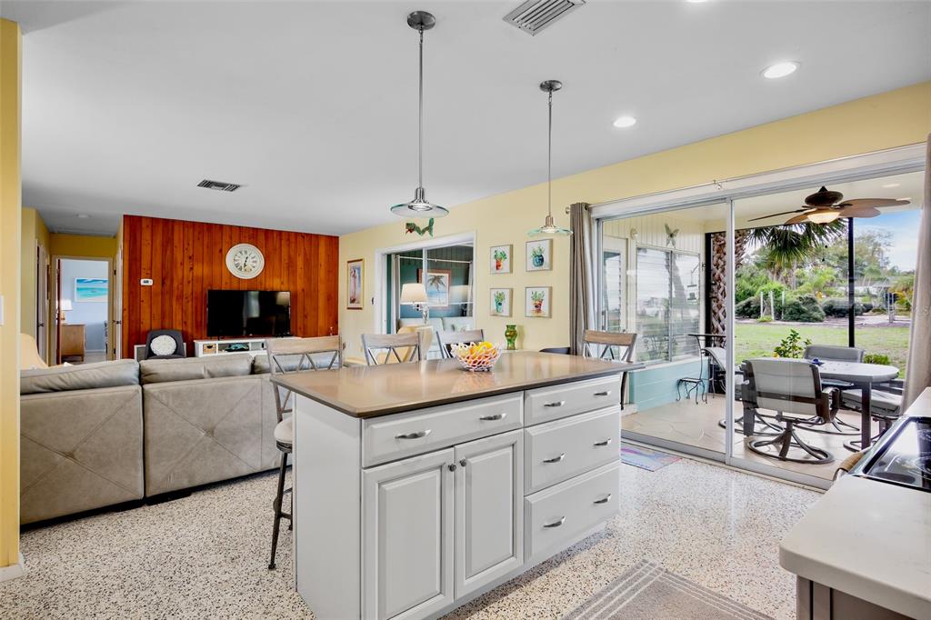 223 Roberts Road Nokomis, FL 34275 - Photo 8 of 27 a living room with kitchen island furniture and a large window