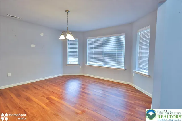a view of a room with windows and wooden floor