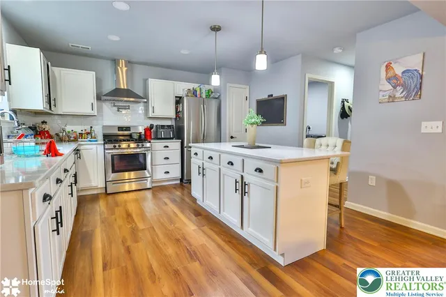 a kitchen with stainless steel appliances a refrigerator sink and cabinets