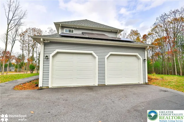 a view of a house with a yard and garage