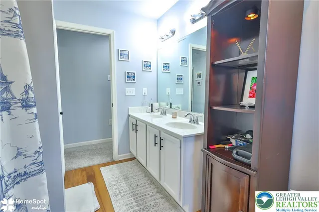 a bedroom with a bed and a lamp on the dresser