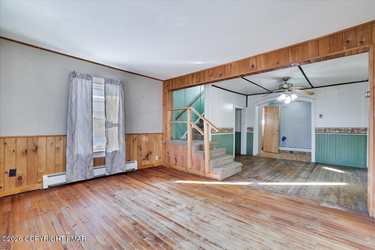 402 Elizabeth Street Towanda, PA 18848 - Photo 2 of 30 an empty room with wooden floor staircase and windows