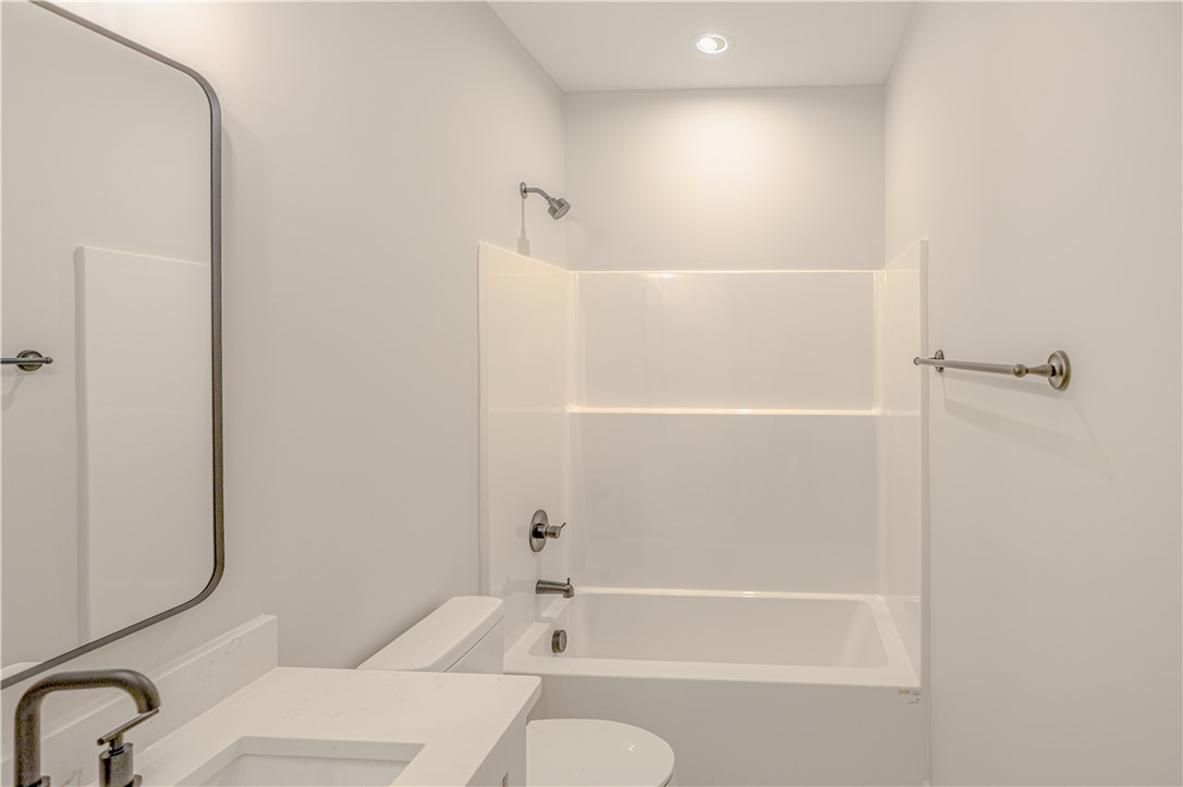 1409 Stonehurst Road Anderson, SC 29621 - Photo 33 of 37 This clean and bright bathroom features a modern vanity and an inviting bathtub shower combination.