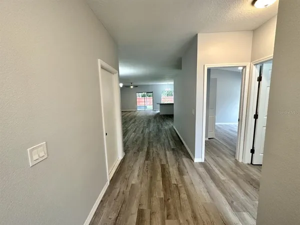 a view of a hallway view with wooden floor and staircase