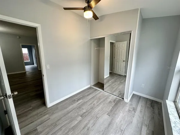 wooden floor in an empty room with a mirror