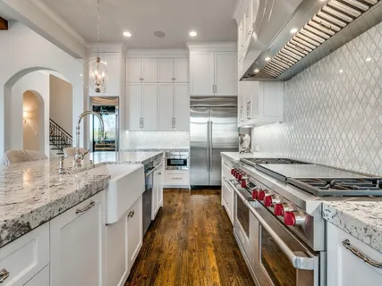a kitchen with granite countertop a stove and a sink