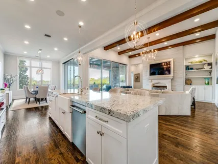 a kitchen with center island and living room
